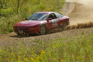 Erick Nelson / Greg Messler drift the back end of their Ford Probe GT through an uphill left on SS10, Chad's Yump.