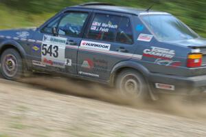 Mike Merbach / Jeff Feldt VW Jetta at speed through a fast uphill left on SS10, Chad's Yump.