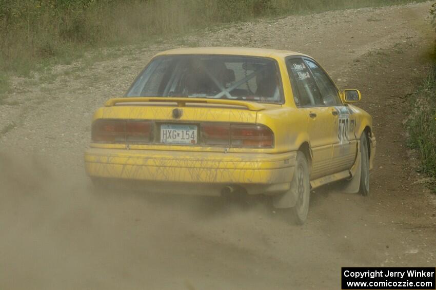 Erik Payeur / Adam Payeur Mitsubishi Galant drifts uphill through the dust on SS10, Chad's Yump.