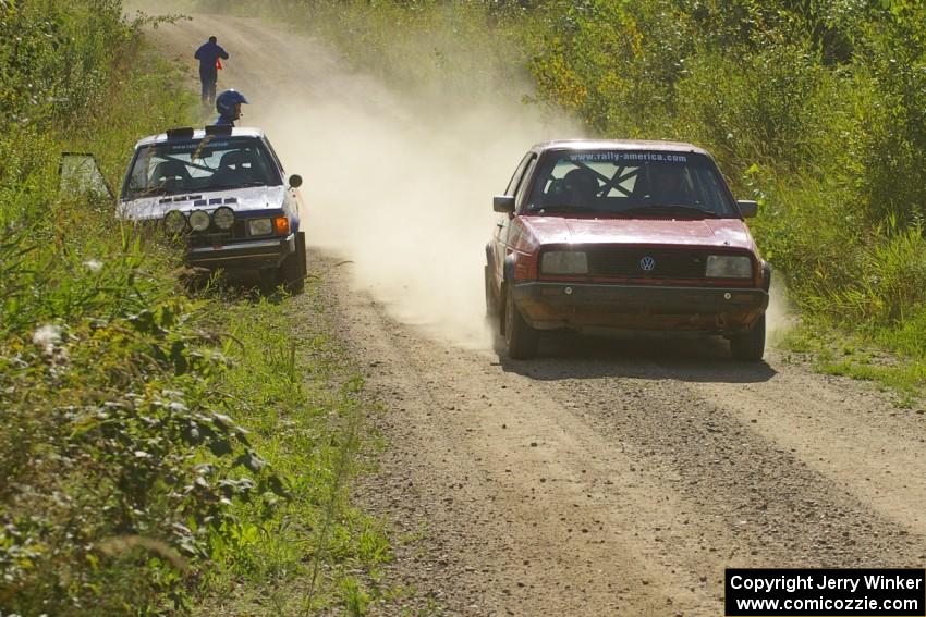 Paul Koll / Matt Wappler VW GTI drives past Dave Sterling/ Stacy Sterling Dodge Omni GLH who DNF'ed with a broken transmission.