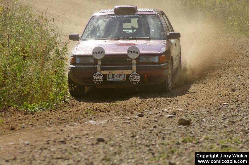 Ben Hanka / John Nordlie Mazda Protege through an uphill left on SS10, Chad's Yump.