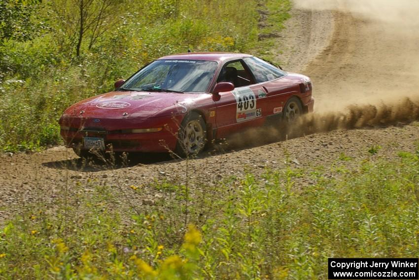 Erick Nelson / Greg Messler drift the back end of their Ford Probe GT through an uphill left on SS10, Chad's Yump.
