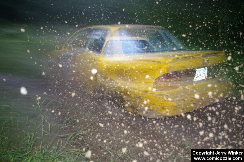 Erik Payeur / Adam Payeur Mitsubishi Galant sprays gravel through the spectator point on SS13, Sockeye Lake.