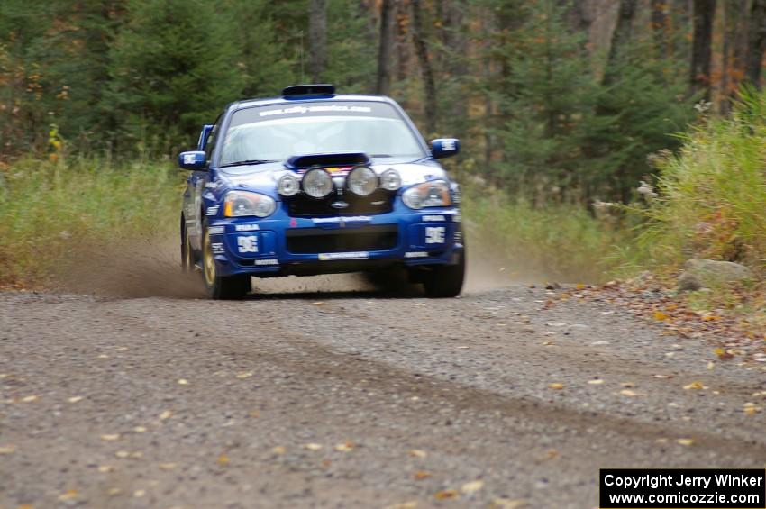 Travis Pastrana / Christian Edstrom Subaru WRX STi heads uphill near the start of SS1, Herman.