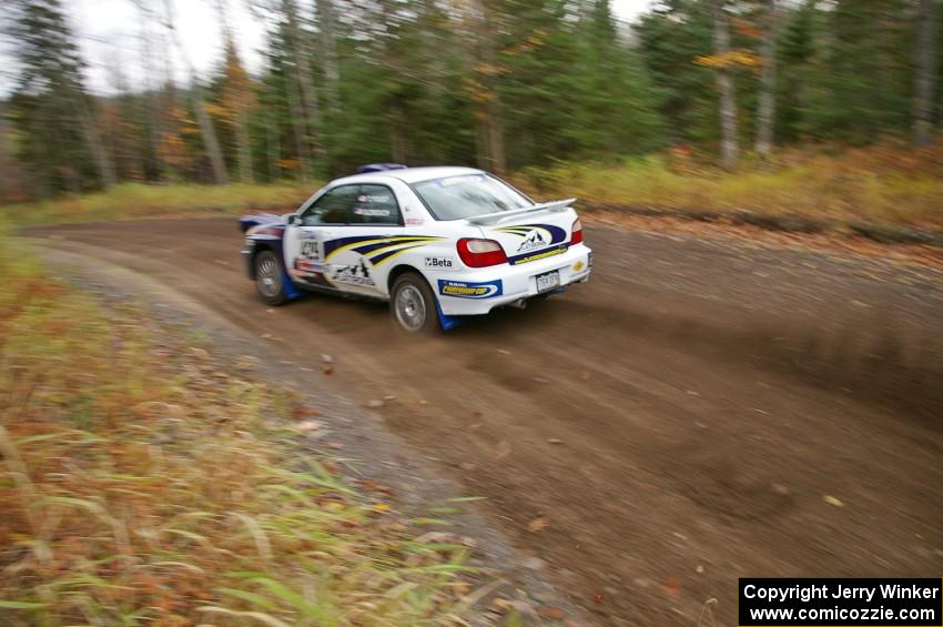 Tanner Foust / Scott Crouch Subaru WRX heads uphill near the start of SS1, Herman.