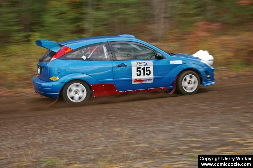 Adam Boullion / Phil Boullion Ford Focus heads uphill near the start of SS1, Herman.