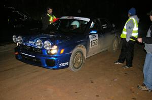 Eric Langbein / Jeremy Wimpey Subaru WRX get their time card handed back at the finish control of SS4, Baraga Plains.