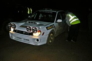 Otis Dimiters / Peter Monin Subaru WRX STi check into the finish control of SS4, Baraga Plains, and are greeted by Russ Johnson.