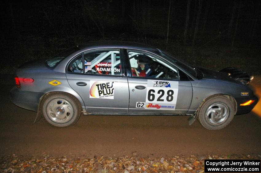 Dan Adamson / Chris Gordon Saturn SL2 crosses the finish of SS2, Menge Creek North.