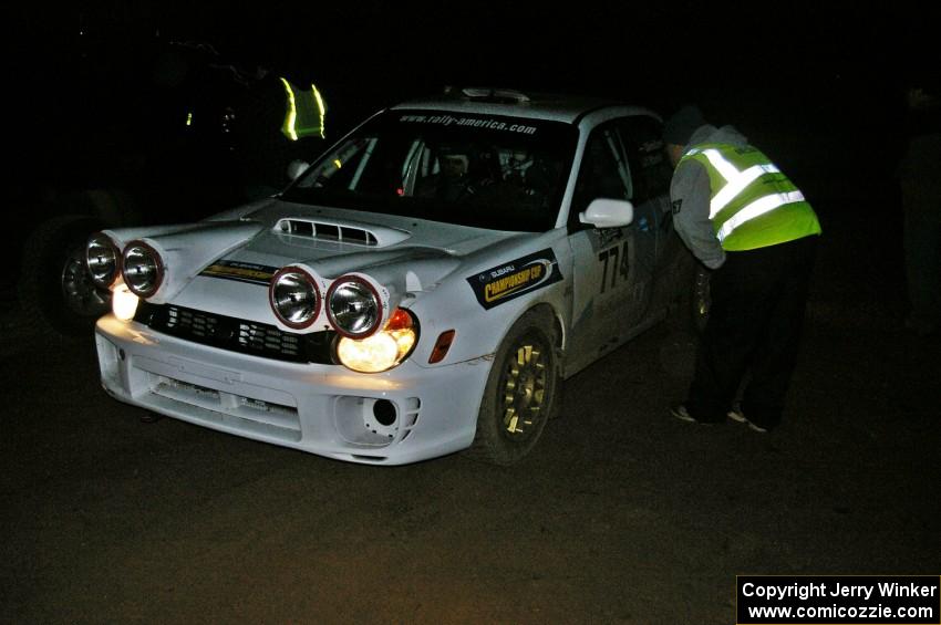 Otis Dimiters / Peter Monin Subaru WRX STi check into the finish control of SS4, Baraga Plains, and are greeted by Russ Johnson.