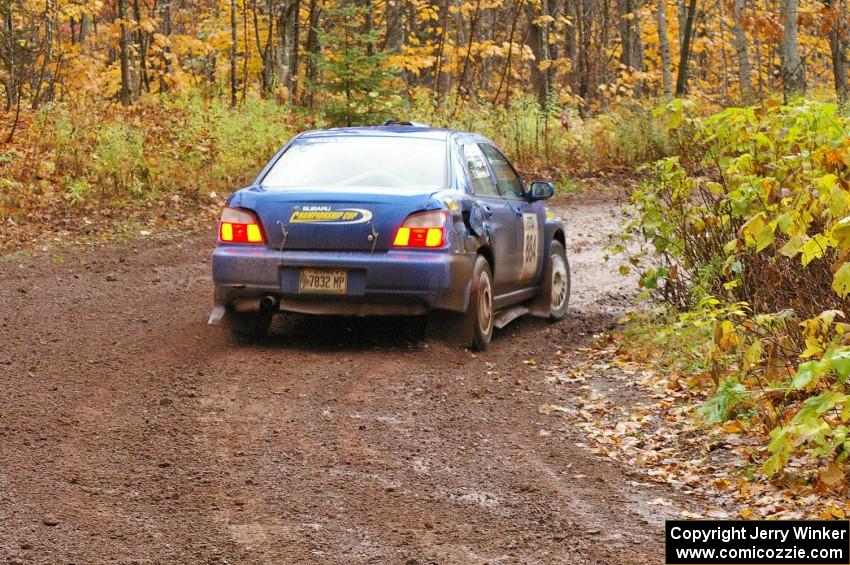 Tim Stevens / Jeff Hagan Subaru WRX drifts the back end through the final muddy corner of Gratiot Lake 1, SS7.