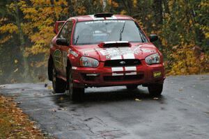 Pat Richard / Nathalie Richard risk nothing while leading at the midpoint jump on Brockway, SS10, in their Subaru WRX STi.