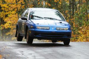 Micah Witala / Jason Takkunen Saturn SL2 get minor air at the midpoint jump on Brockway, SS10.