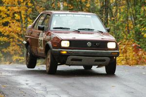 Matt Bushore / Andy Bushore VW Jetta takes it easy over the midpoint jump on Brockway, SS10.