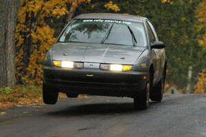 Dan Adamson / Chris Gordon Saturn SL2 gets the right side light at the midpoint jump on Brockway, SS10.