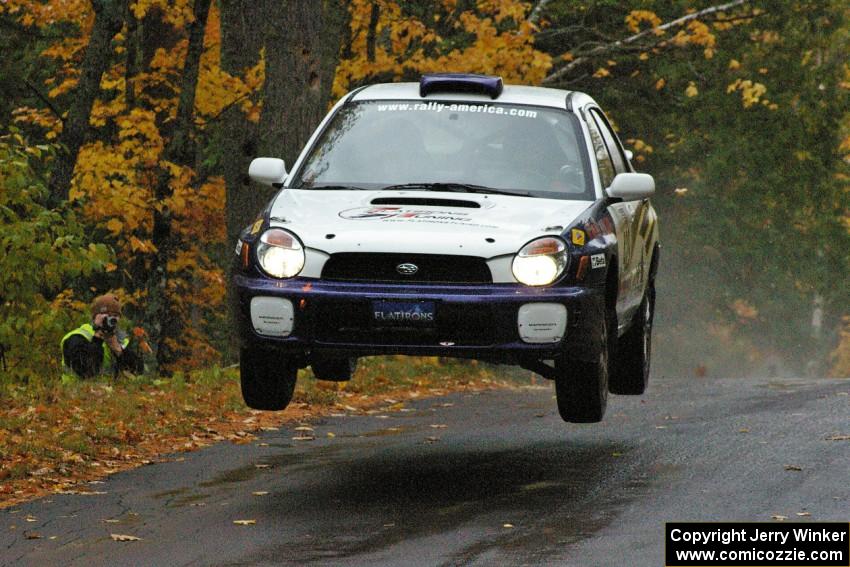 Tanner Foust / Scott Crouch Subaru WRX catches nice air at the midpoint jump on Brockway, SS10.