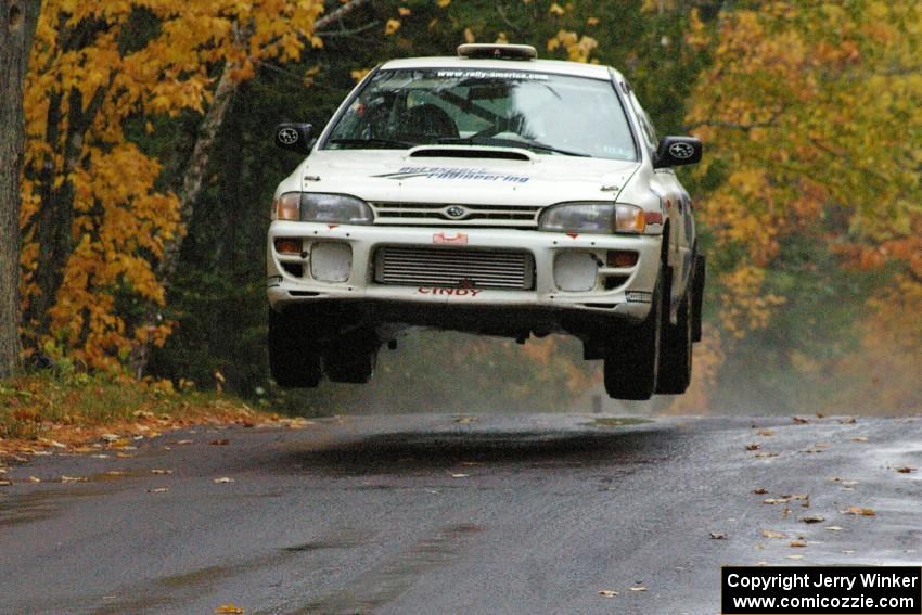 Henry Krolikowski / Cindy Krolikowski Subaru WRX catches nice air at the midpoint jump on Brockway, SS10.