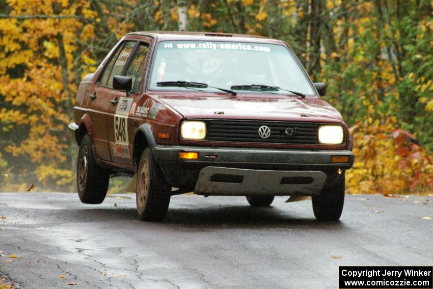 Matt Bushore / Andy Bushore VW Jetta takes it easy over the midpoint jump on Brockway, SS10.