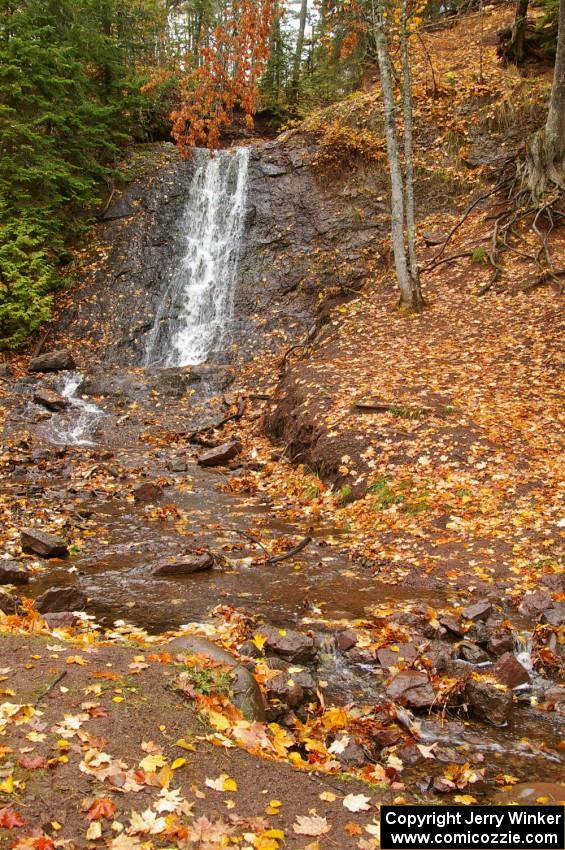 Freshly fallen yellow leaves surround Haven Falls just to the west of Lac La Belle, MI