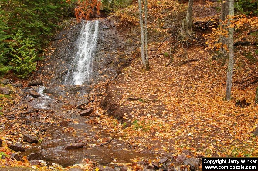 Freshly fallen yellow leaves surround Haven Falls just to the west of Lac La Belle, MI