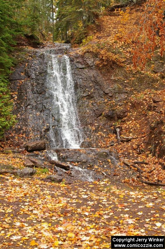 Freshly fallen yellow leaves surround Haven Falls just to the west of Lac La Belle, MI