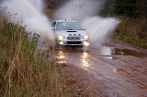 Tom Nelson in his Subaru WRX 0 car hits the final puddle near the finish of Gratiot Lake 2.