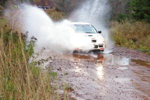 Alfredo De Dominicis / Massimo Daddoveri Mitsubishi Lancer Evo 7 hits the final big puddle at Gratiot Lake 2, SS14, at speed.