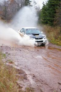 Ken Block / Alex Gelsomino Subaru WRX STi hits the final big puddle at the end of Gratiot Lake 2, SS14, at speed.