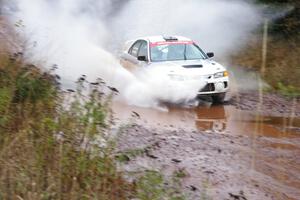 Chris Gilligan / Joe Petersen Mitsubishi Lancer Evo IV hits the final big puddle at the end of Gratiot Lake 2, SS14, at speed.