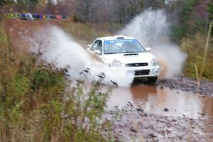 Fintan McCarthy / Noel Gallagher Subaru WRX STi hits the final big puddle at the end of Gratiot Lake 2, SS14, at speed.