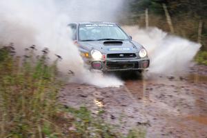 Dave Anton / Alan Ockwell Subaru WRX STi hits the final big puddle at the end of Gratiot Lake 2, SS14, at speed.