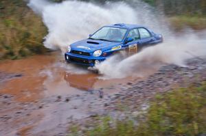 Tim Stevens / Jeff Hagan Subaru WRX hits the final big puddle at the end of Gratiot Lake 2, SS14, at speed.