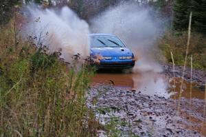 Micah Witala / Jason Takkunen Saturn SL2 hits the final big puddle at the end of Gratiot Lake 2, SS14, at speed.