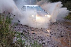 Joel Sanford / Jeff Hribar Chevy Cavalier hits the final big puddle at the end of Gratiot Lake 2, SS14, at speed.