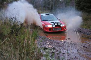 John Rek / Rob Dupree Mitsubishi Lancer Evo 6.5 hits the final big puddle at the end of Gratiot Lake 2, SS14, at speed.