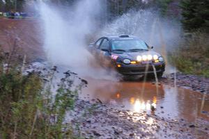 Bryan Holder / Tracy Payeur Plymouth Neon hits the final big puddle at the end of Gratiot Lake 2, SS14, at speed.