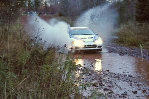 Paul Ritchie / Drew Ritchie Mitsubishi Eclipse GSX hits the final big puddle at the end of Gratiot Lake 2, SS14, at speed.