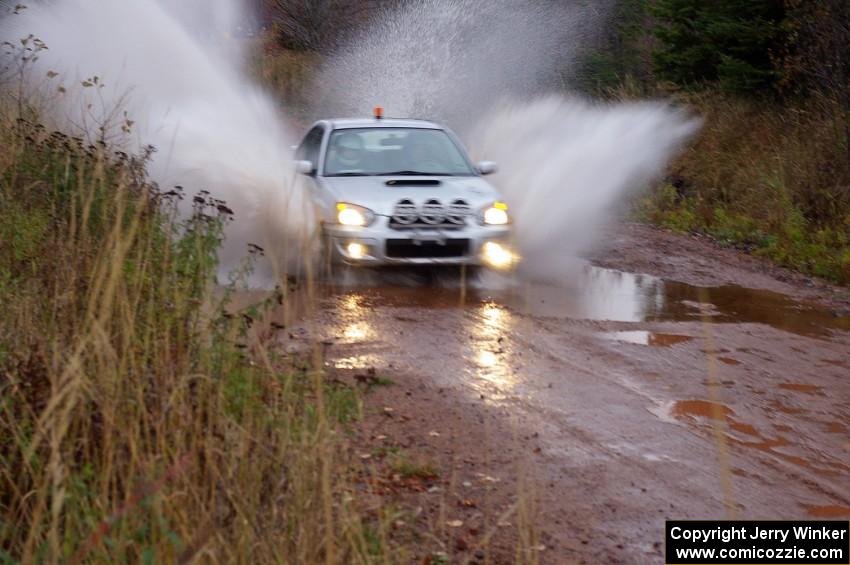 Tom Nelson in his Subaru WRX 0 car hits the final puddle near the finish of Gratiot Lake 2.