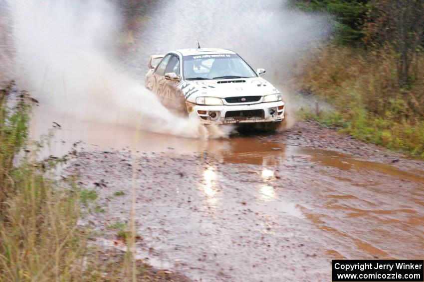 Matt Iorio / Ole Holter Subaru Impreza hits the final big puddle at the end of Gratiot Lake 2, SS14, at speed.