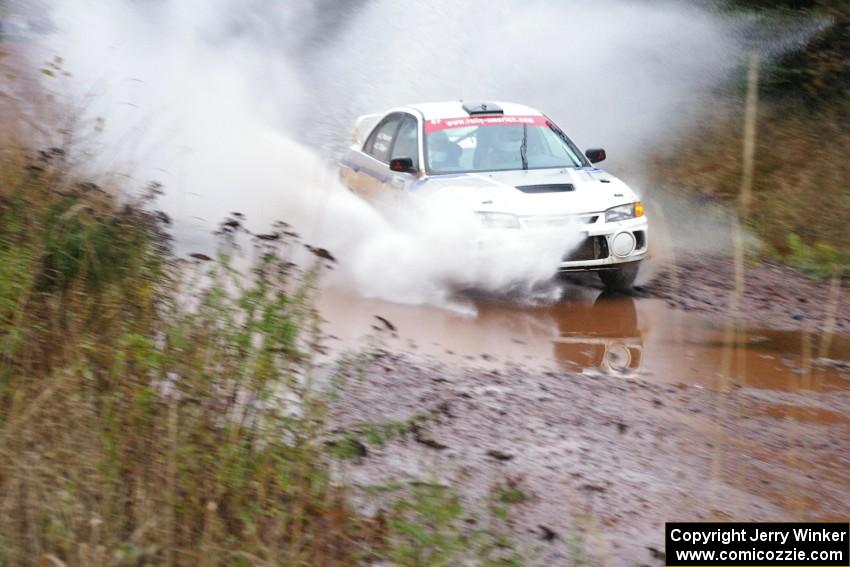 Chris Gilligan / Joe Petersen Mitsubishi Lancer Evo IV hits the final big puddle at the end of Gratiot Lake 2, SS14, at speed.