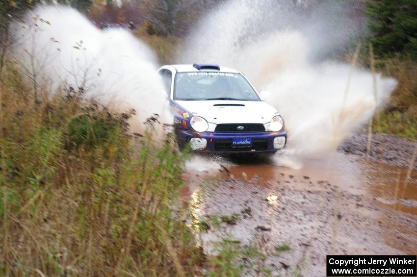 Tanner Foust / Scott Crouch Subaru WRX hits the final big puddle at the end of Gratiot Lake 2, SS14, at speed.