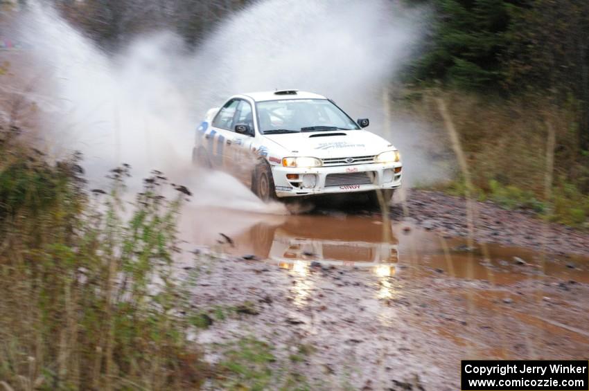 Henry Krolikowski / Cindy Krolikowski Subaru WRX hits the final big puddle at the end of Gratiot Lake 2, SS14, at speed.
