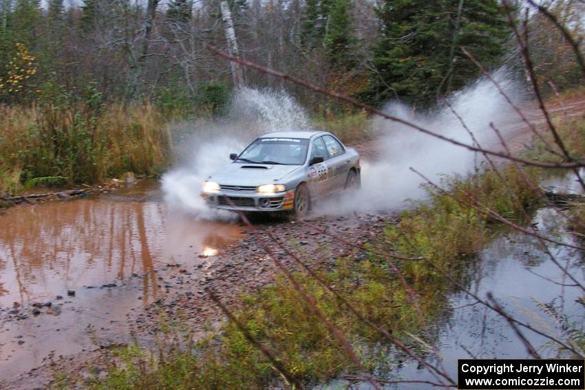Russ Hodges / Mike Rossey Subaru Impreza hits the final big puddle at the end of Gratiot Lake 2, SS14, at speed.