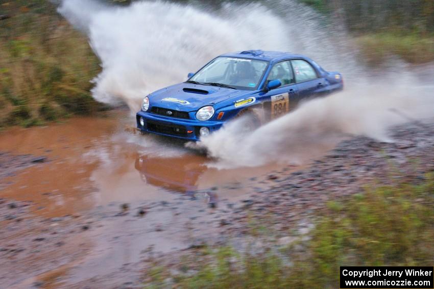 Tim Stevens / Jeff Hagan Subaru WRX hits the final big puddle at the end of Gratiot Lake 2, SS14, at speed.