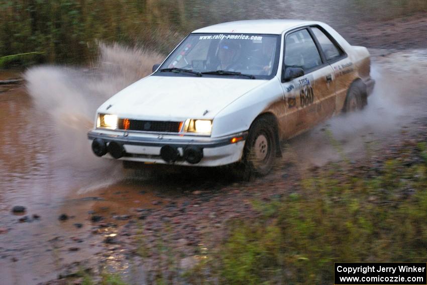 Greg Woodside / Tom Woodside Dodge Shadow Turbo hits the final big puddle at the end of Gratiot Lake 2, SS14, at speed.