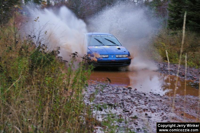 Micah Witala / Jason Takkunen Saturn SL2 hits the final big puddle at the end of Gratiot Lake 2, SS14, at speed.