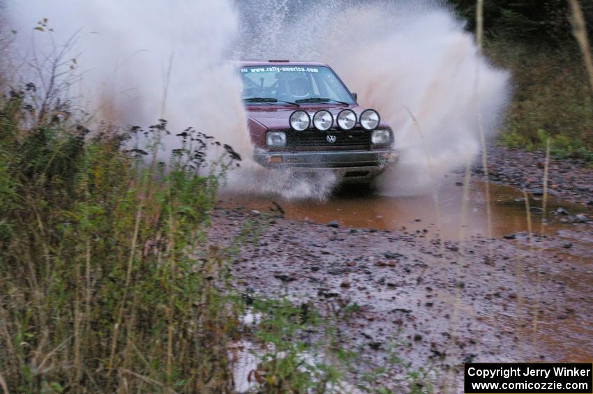 Matt Bushore / Andy Bushore VW Jetta hits the final big puddle at the end of Gratiot Lake 2, SS14, at speed.