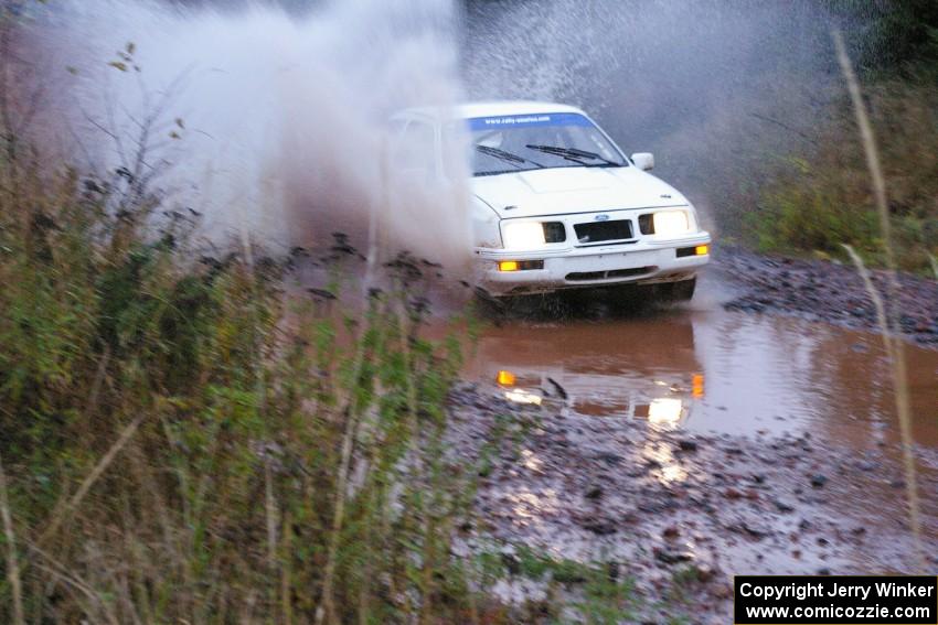 Colin McCleery / Nancy McCleery	Ford Sierra XR8 hits the final big puddle at the end of Gratiot Lake 2, SS14, at speed.