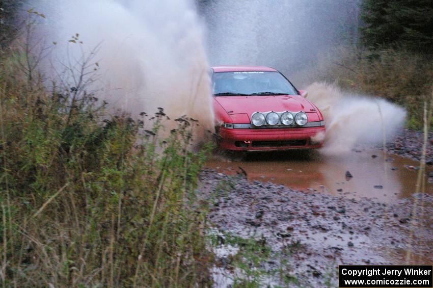 Marcin Kowalski / Maciej Sawicki Mitsubishi Eclipse GST hits the final big puddle at the end of Gratiot Lake 2, SS14, at speed.