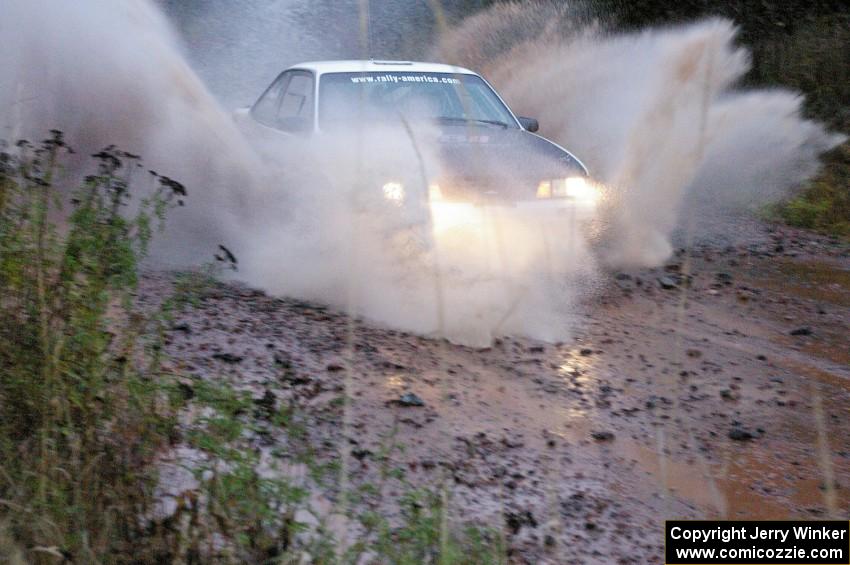 Joel Sanford / Jeff Hribar Chevy Cavalier hits the final big puddle at the end of Gratiot Lake 2, SS14, at speed.